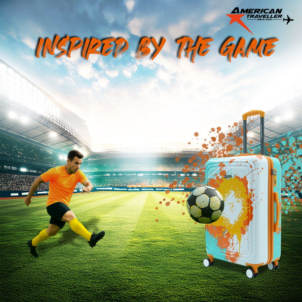 Football-themed designer hard case luggage with splash-paint print, placed in a stadium with a player kicking a ball toward the suitcase
